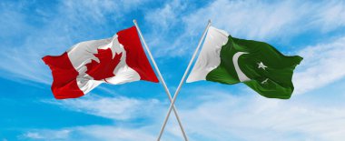 Kanada ve Pakistan 'ın ulusal bayraklarını aştı bulutlu gökyüzünde rüzgarda dalgalanan bayrak. İlişkiyi, diyaloğu, iki ülke arasında seyahat etmeyi sembolize ediyor. Boşluğu kopyala