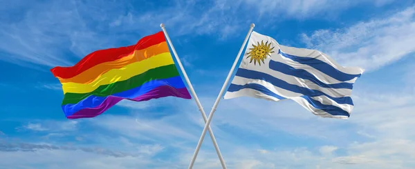 Crossed Flags Lgbt Uruguay Flag Waving Wind Cloudy Sky Freedom — стоковое фото