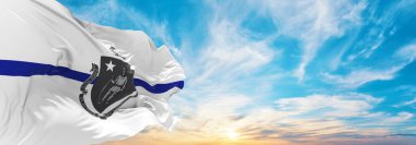 blue line flag of Massachusetts state, Usa at cloudy sky background on sunset, panoramic view. United states of America police flag. copy space for wide banner clipart