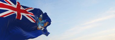 Tristan da Cunha 'nın resmi bayrağı bulutlu arka planda günbatımında, panoramik manzarada. Vatansever ve seyahat kavramı. Geniş afiş afiş için boşluk kopyala. 3d illüstrasyon