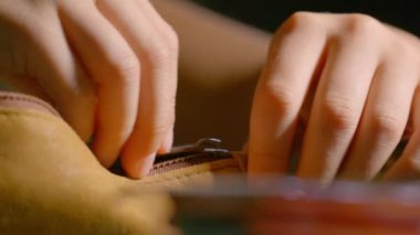 Young schoolboy is closing a school kit case