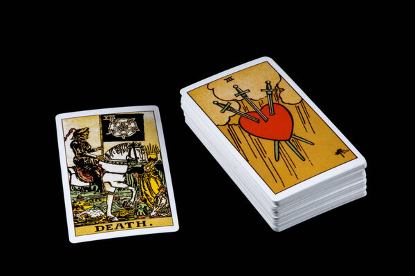 Single tarot card with deck isolated on a black background