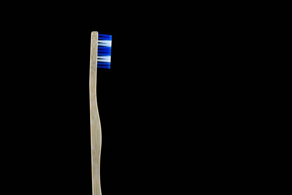 Upright Bamboo Toothbrush Blue White Bristles Isolated Black Background — Zdjęcie stockowe