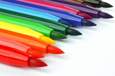 Multi-colored markers on white background. Place for text