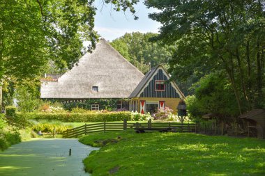 Breezand, Netherlands. August 2022. Dutch farmhouse with barn on a sunny day. High quality photo