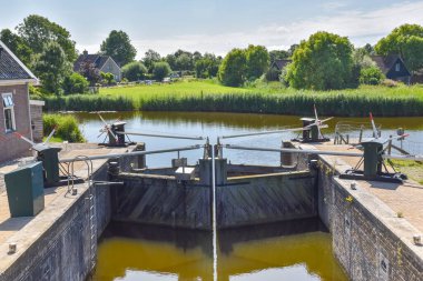 Oudesluis, Netherlands. August 2022. A small manually operated lock in the polder of North Holland. High quality photo