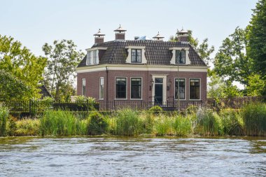 Amsterdam, Netherlands. August 2022. The mansions along the river Amstel near Amsterdam. High quality photo