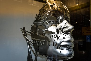 Amsterdam, the Netherlands - September 18, 2020. Modern art - a silver mask - in the shop window of an art gallery in Amsterdam, Holland.