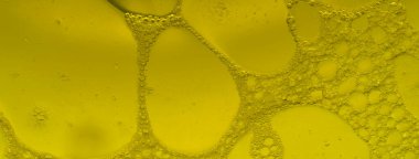 Sarı köpüklü pankart, sarı sıvı sabun köpüğü. Dokuyu kapat. Düz üst görünüm