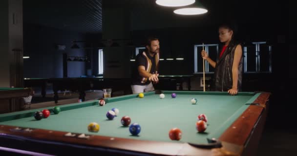 一个年轻的男人和一个女人在玩台球，聊天，喝啤酒. — 图库视频影像