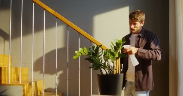En man tvättar ledstänger i trappan, sprutar vätska från en pultilizer — Stockvideo