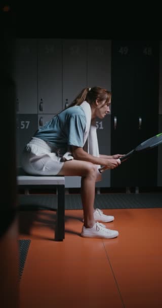 Young woman tennis player is resting in the locker room after the match — Stock Video