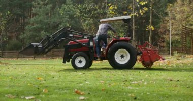 Genç adam gelir, oturur, döner ve küçük bir çiftlik traktörü sürmeye başlar.