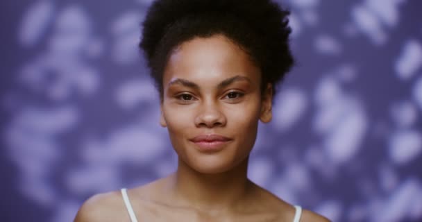 African American model smiling looking at camera standing of falling rose petals — Video Stock