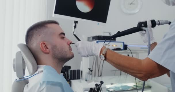 An ENT examines the patients sinuses using a medical mini camera — Stock Video