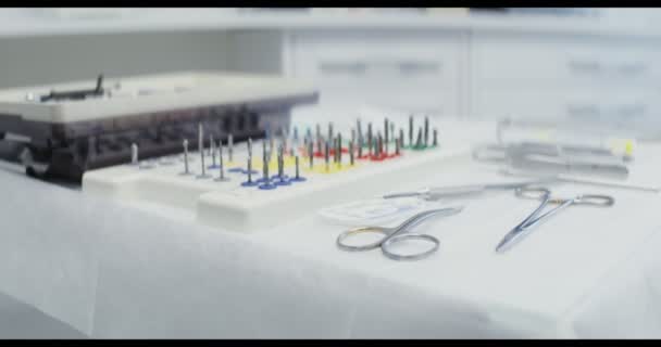 A dentists table prepared for work with dental instruments laid out on it — Stock Video