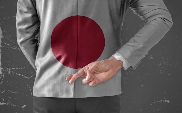 Businessman Jacket with Flag of Japan with his fingers crossed behind his back