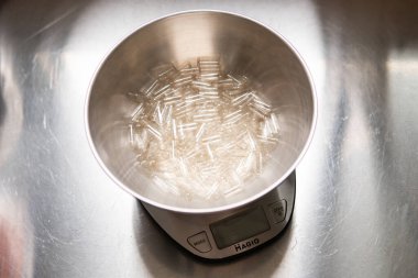 Kapsül dolum makinesi. Beslenme takviyeleri için şeffaf kapsüller.