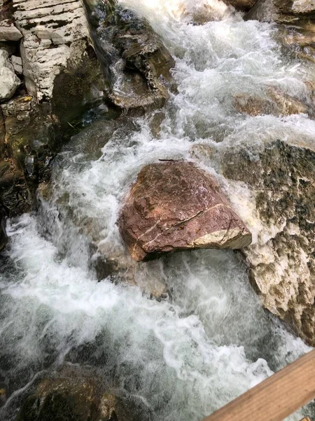 Çalkantılı dağ nehri taşların arasından geçiyor.