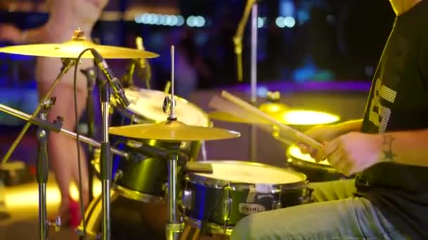 Мариуполь, Украина - 25 июля 2021 года. Силуэт ударной руки с барабанной палочкой играет на барабанах. Музыкант выступает на сцене. Крупный план игры на барабанах на рок-концерте. Рок-группа выступает на сцене. — стоковое видео