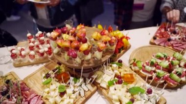 Catering service on banquet table with canape snacks in restaurant or hotel. Decorated food set on birthday, wedding celebration or business conference event venue.