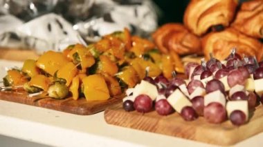 Catering service on banquet table with canape snacks in restaurant or hotel. Decorated food set on birthday, wedding celebration or business conference event venue.