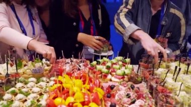 Catering service on banquet table with canape snacks in restaurant or hotel. Decorated food set on birthday, wedding celebration or business conference event venue.