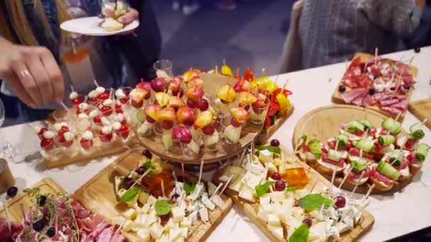 Catering service on banquet table with canape snacks in restaurant or hotel. Decorated food set on birthday, wedding celebration or business conference event venue. — Video