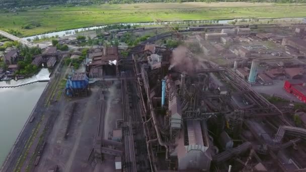 Aerial of industrial city with air atmosphere and river water pollution from metallurgical plant and blast furnaces near sea. Dirty smoke, smog from pipes of steel factory. Ecological issues concept. — Video Stock