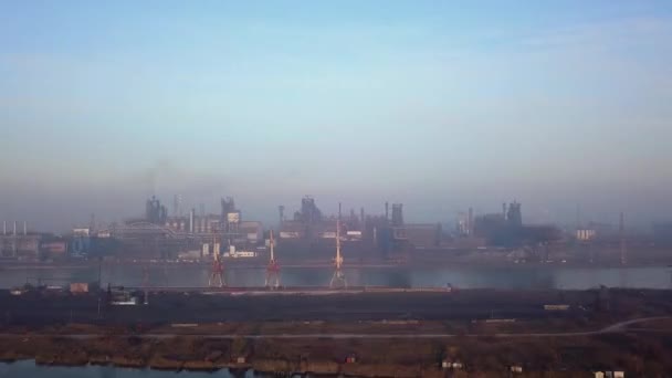 Aerial of industrial city with air atmosphere and river water pollution from metallurgical plant and blast furnaces near sea. Dirty smoke, smog from pipes of steel factory. Ecological issues concept. — Vídeos de Stock