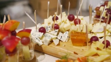 Catering service on banquet table with canape snacks in restaurant or hotel. Decorated food set on birthday, wedding celebration or business conference event venue.