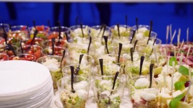 Catering service on banquet table with canape snacks in restaurant or hotel. Decorated food set on birthday, wedding celebration or business conference event venue.