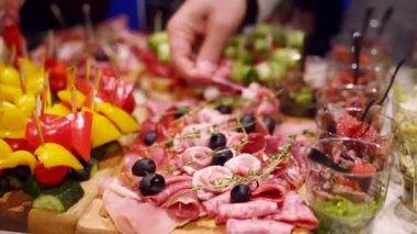 Catering service on banquet table with canape snacks in restaurant or hotel. Decorated food set on birthday, wedding celebration or business conference event venue.