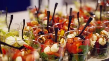Catering service on banquet table with canape snacks in restaurant or hotel. Decorated food set on birthday, wedding celebration or business conference event venue.