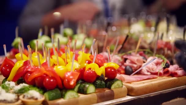 Catering service on banquet table with canape snacks in restaurant or hotel. Decorated food set on birthday, wedding celebration or business conference event venue. — Stockvideo