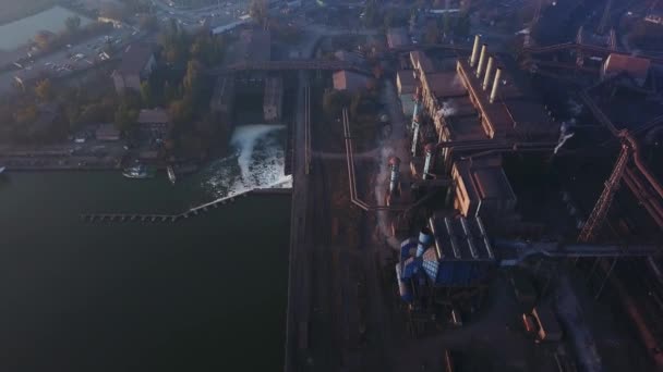 Aerial of industrial city with air atmosphere and river water pollution from metallurgical plant and blast furnaces near sea. Dirty smoke, smog from pipes of steel factory. Ecological issues concept. — 비디오