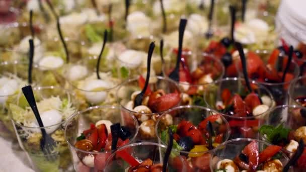 Catering service on banquet table with canape snacks in restaurant or hotel. Decorated food set on birthday, wedding celebration or business conference event venue. — Stockvideo