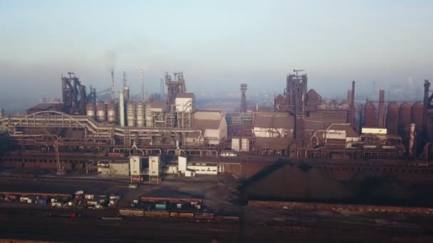 Aerial of industrial city with air atmosphere and river water pollution from metallurgical plant and blast furnaces near sea. Dirty smoke, smog from pipes of steel factory. Ecological issues concept. — Stockvideo