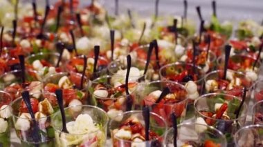 Catering service on a banquet table with canape snacks in restaurant or hotel. Decorated food set on birthday, wedding celebration or business conference event venue.