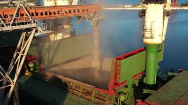 Deniz limanındaki deniz tahıl asansöründe yük ambarına buğday havası yükleniyor. Buğday sevkiyatı. Terminal limanındaki bir sandık vasıtasıyla. Tarım ürünlerinin nakliyesi.