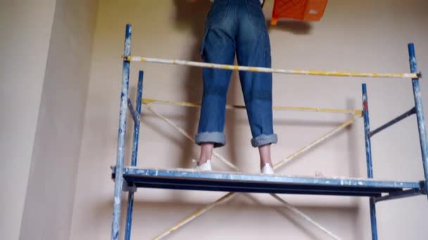 Professional Painter Female Paints Wall Roller Scaffolding Construction Site Young — Wideo stockowe