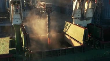 Deniz limanındaki deniz tahıl asansöründe yük ambarına buğday havası yükleniyor. Buğday, terminal limanındaki gövde vasıtasıyla ambardan gövdeye dökülüyor. Tarım ürünlerinin nakliyesi.