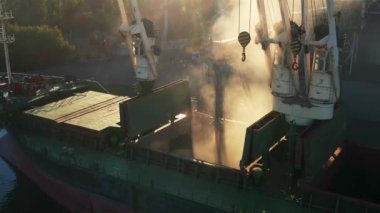 Deniz limanındaki deniz tahıl asansöründe yük ambarına buğday havası yükleniyor. Buğday, terminal limanındaki gövde vasıtasıyla ambardan gövdeye dökülüyor. Tarım ürünlerinin nakliyesi.