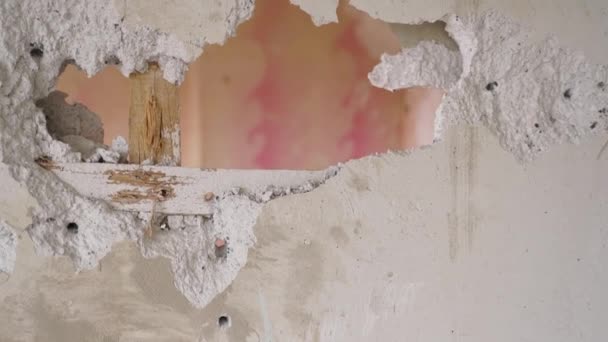 請負業者は 壁の穴に親指のサインを表示し アパートの再配置作業を楽しんでいます 解体と解体を行う男は改装のために働く 制服とハートの建設労働者 — ストック動画
