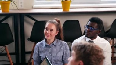 Businessman reporting to multiethnic partners audience in conference room. Diverse international team listen to CEO on meeting in office. Corporate people discuss business strategy on briefing.