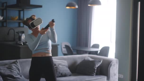 Young Futuristic Blonde Girl Wearing Virtual Reality Headset Holding Controller — 비디오