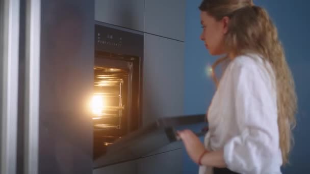 Caucasian Woman Opens Door Heated Oven Puts Pot Baking Closes — Vídeos de Stock