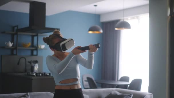 Young Futuristic Blonde Girl Wearing Virtual Reality Headset Holding Controller — Stok video