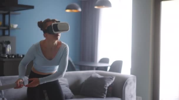 Young Futuristic Blonde Girl Wearing Virtual Reality Headset Holding Controller — Video Stock
