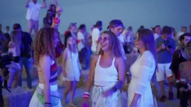 2020-07-25 - Henychensk, Ukraine. Spot Guide Kite Club - Wave Festival. Multi ethnic people in boho outfits dance enjoy open air music fest on sunset by sea. Stylish audience have fun on beach party.